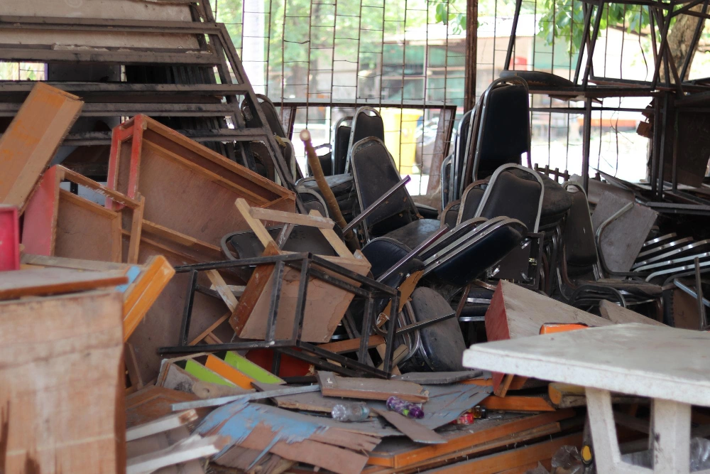 Stacked chairs, broken furniture, and debris prepared for removal during a junk removal service by Dump Pro LA in Los Angeles